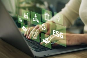 Mãos de uma executiva digitando em um laptop, planejando ações com impacto social e alinhado com causas naturais para a empresa