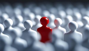 Figura vermelha que se destaca entre a multidão branca, representando o processo de recrutamento e indicadores de recrutamento e seleção