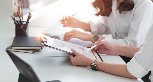 pessoas examinam currículos e realizam avaliação por competência