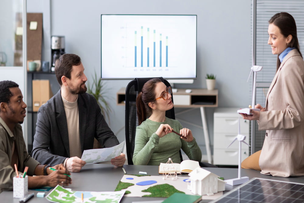 grupo de quatro pesquisadores empresariais diversos composto por duas mulheres e dois homens em uma reunião.